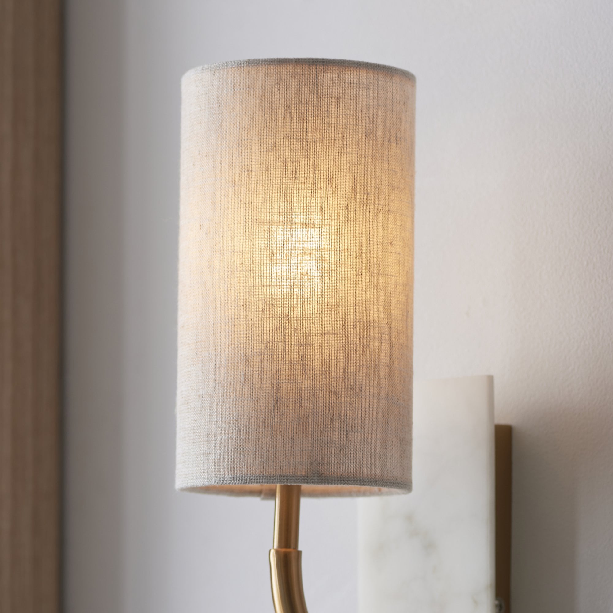 Utopia Spire Single White Marble Curved Arm Wall Light - Vintage Brass & Natural Cylindrical Shade