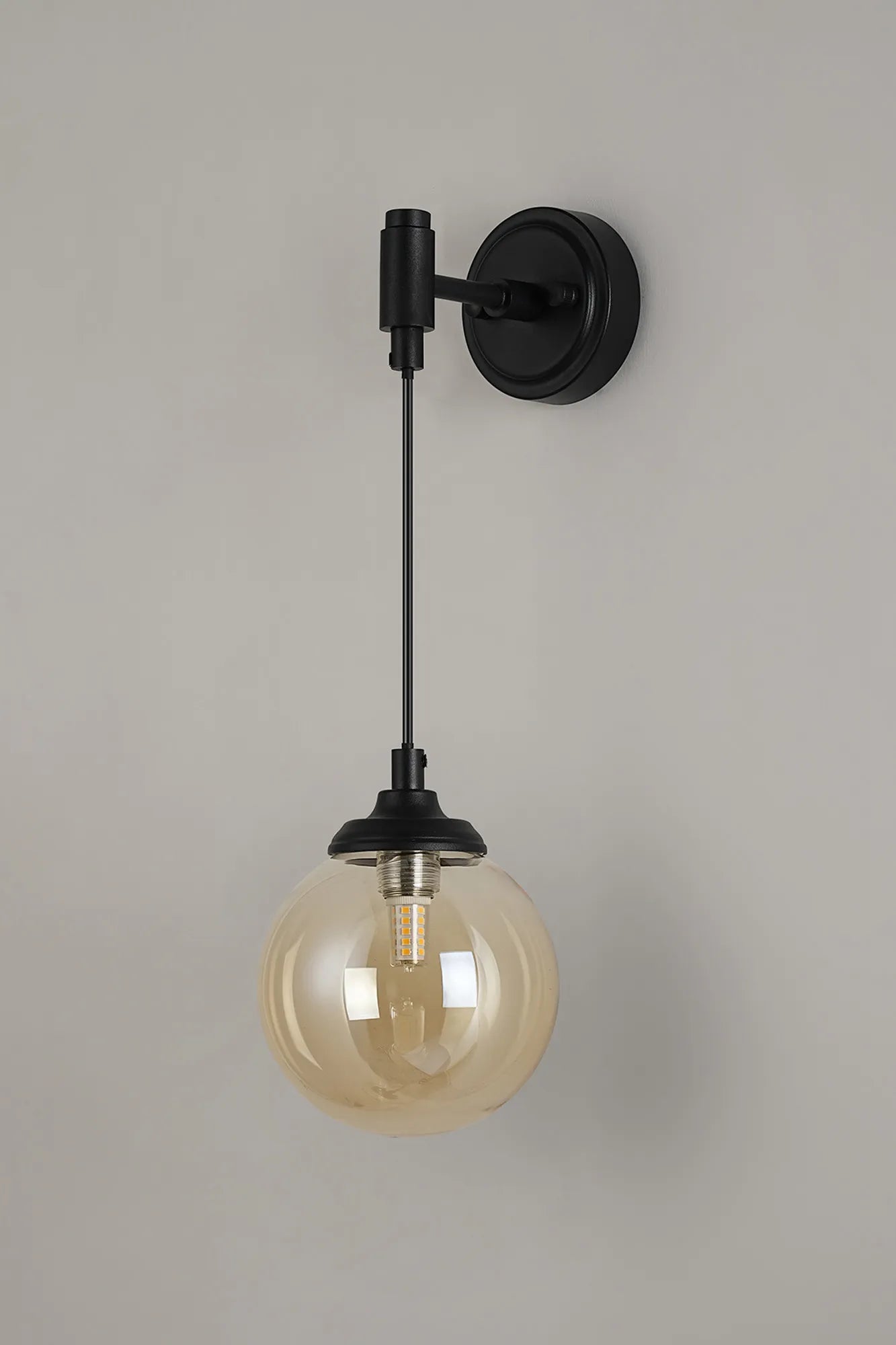 Dene Adjustable Single Wall Light IP44 - Satin Black & Amber Smooth Round Glass