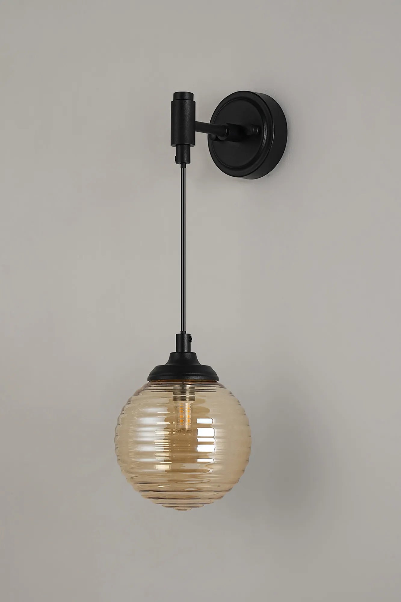 Dene Adjustable Single Wall Light IP44 - Satin Black & Amber Ribbed Round Glass