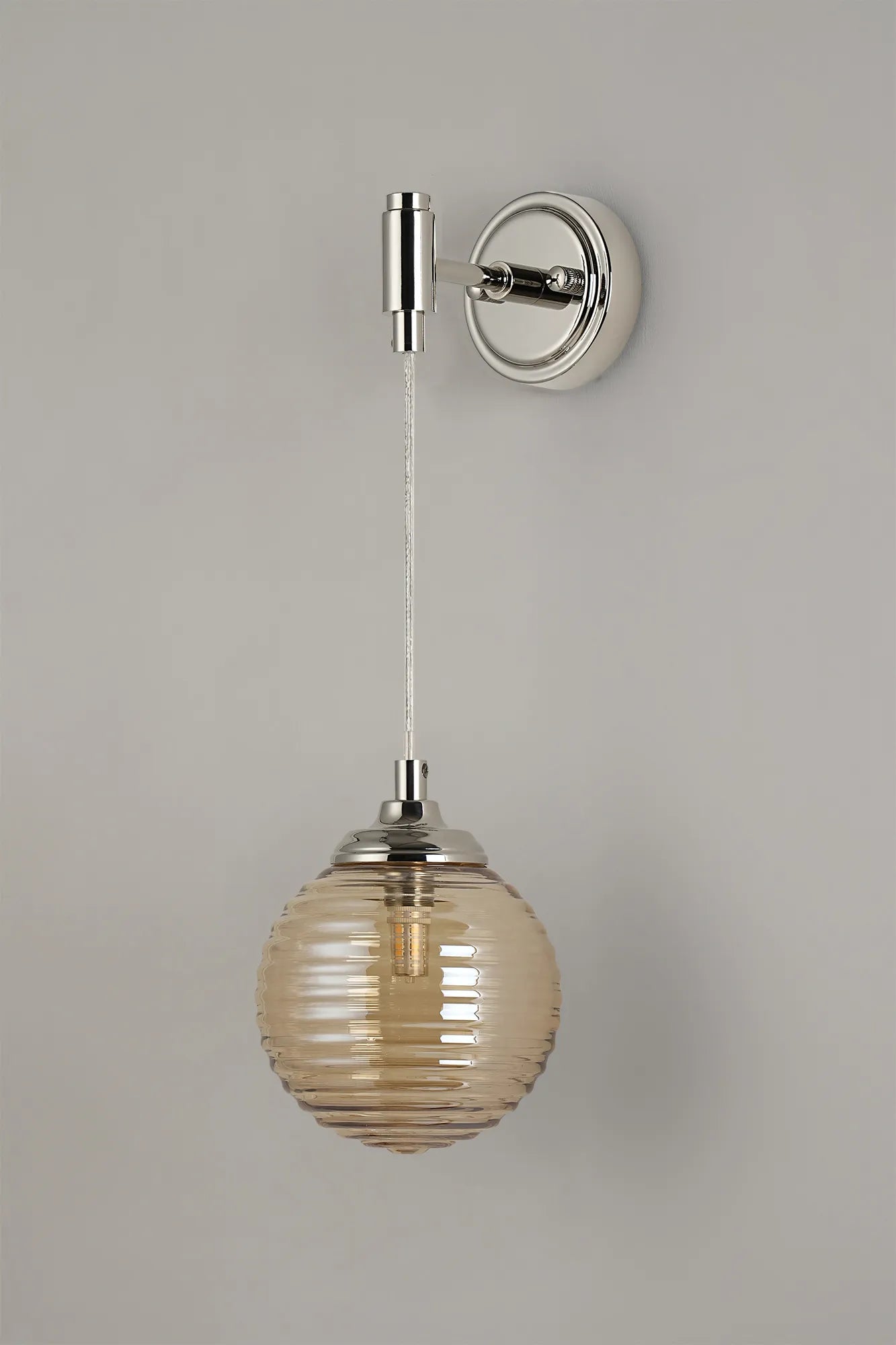 Dene Adjustable Single Wall Light IP44 - Polished Nickel & Amber Ribbed Round Glass
